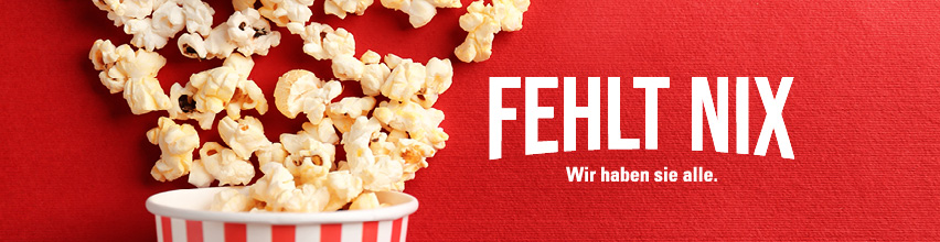 Motiv: Becher Popcorn, viele ausgeschüttete Körner. Zeile: „Fehlt nix. Wir haben sie alle.“